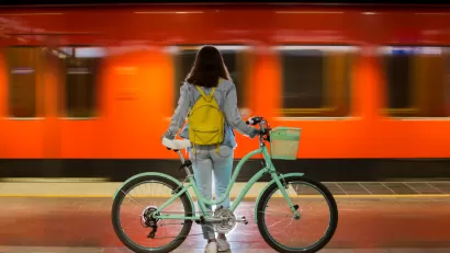 Woman with bicycle on train platform